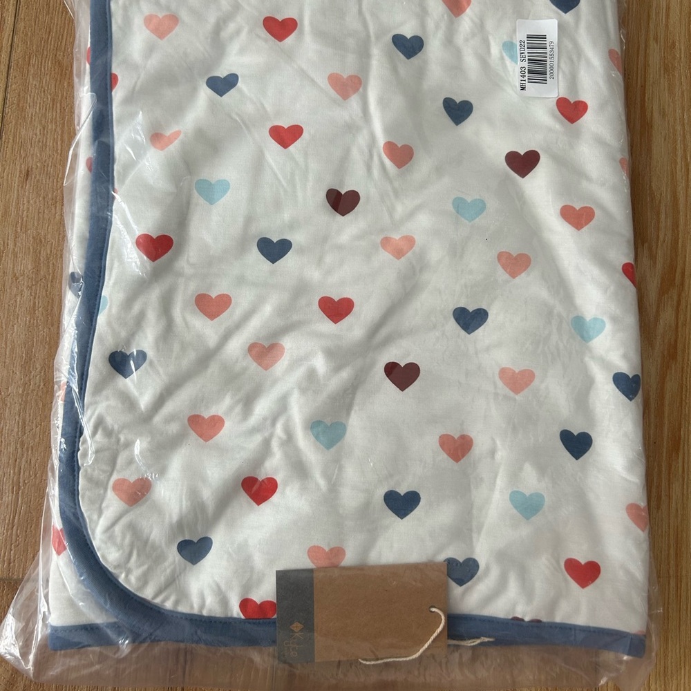 Kyte Baby multi hearts baby blanket with steel background
